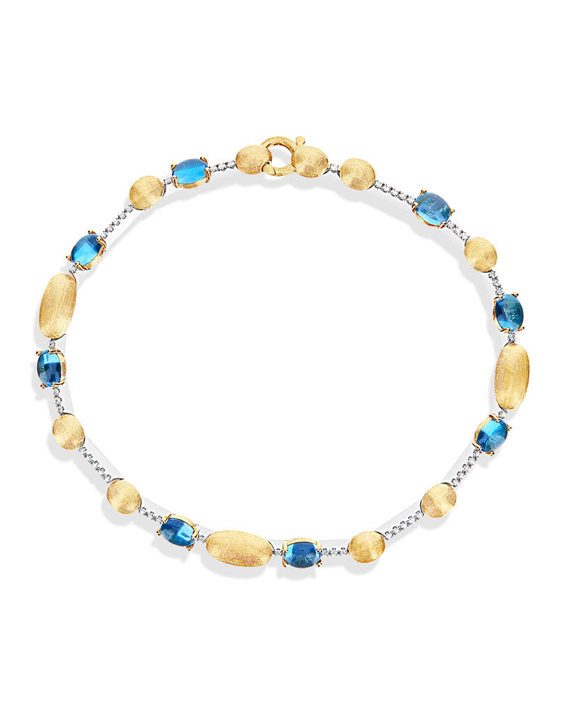 Bracciale tennis "DANCING AZURE" in oro, diamanti e topazio London blu