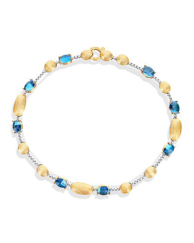 Bracciale tennis "DANCING AZURE" in oro, diamanti e topazio London blu